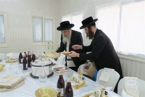 Rabbi Rosenfeld director of the org. is preparing the seder table