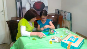 Grandmother and granddaughter work on a Totally Teva craft